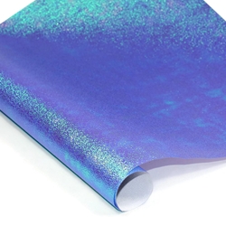 An example of shiny blue, green, and purple iridescent paper called "Purple Haze" on a white background. 